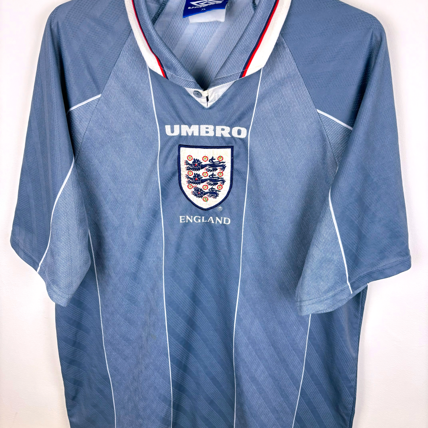 Angled side view of an England classic football shirt produced by Umbro