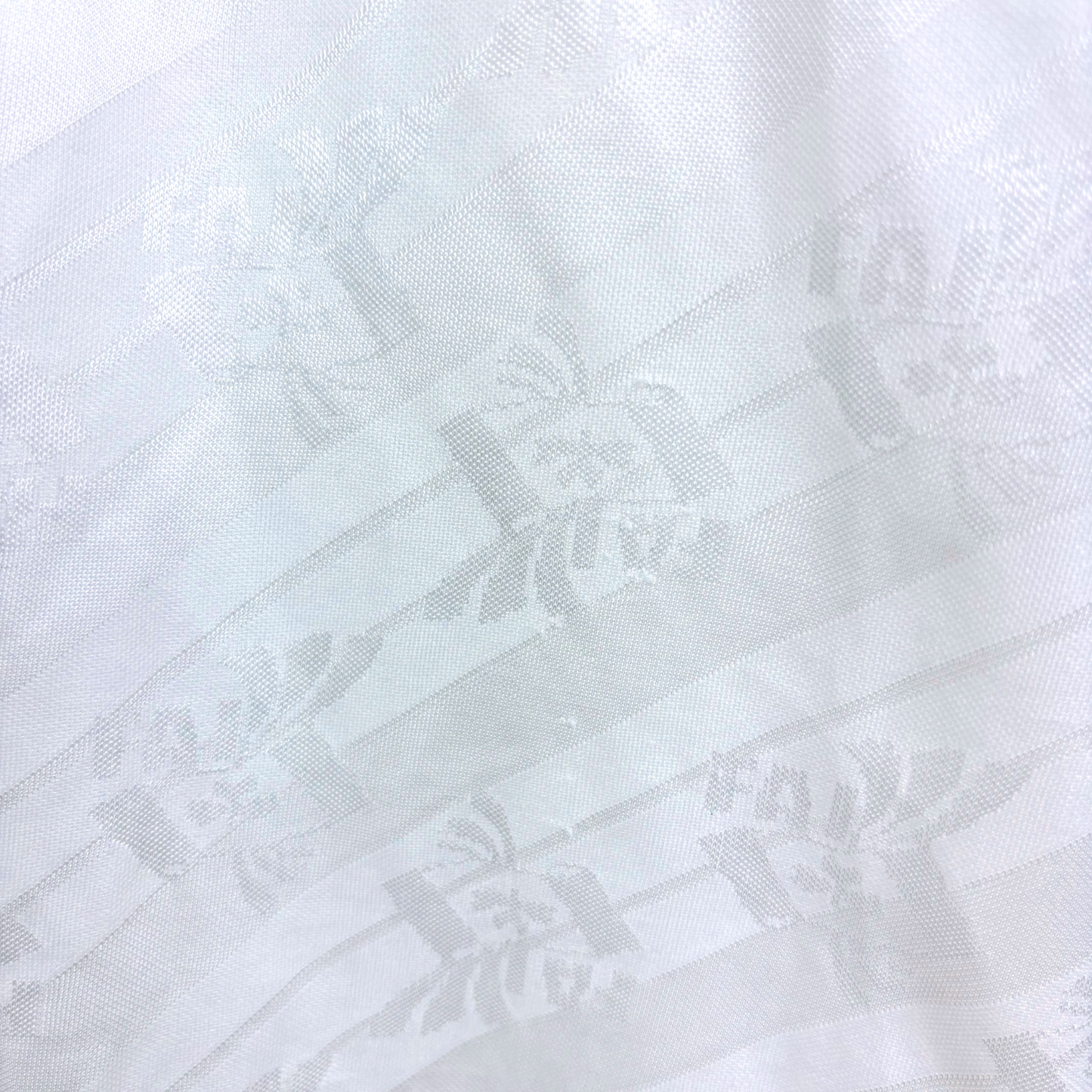 White vintage football shirt with subtle embossed Ireland emblem pattern and Adidas logo, retro soccer jersey style. - Eire Ireland 1994-1995 USA World Cup Away Football Shirt Adidas