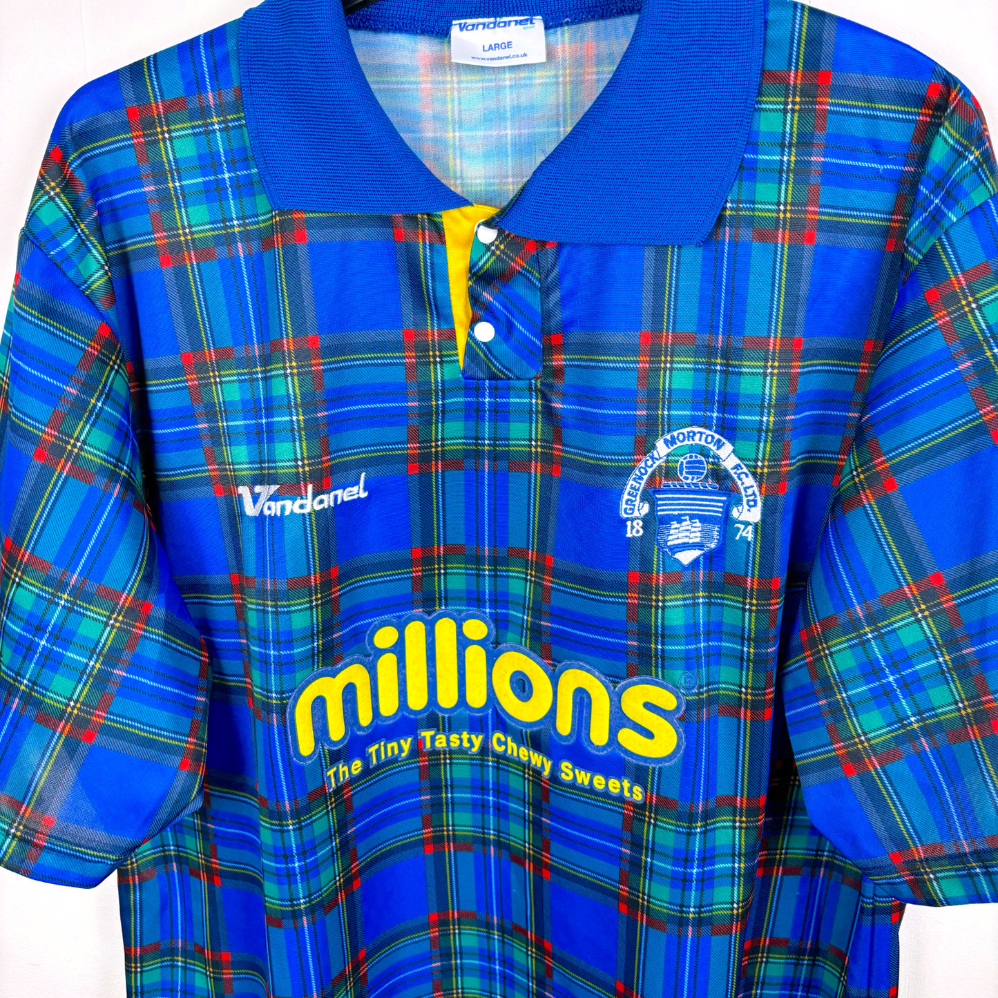 Side angled view of Greenock Morton 2005 retro football shirt produced by Vandanel. Tartan design with yellow 'Millions' sponsor.