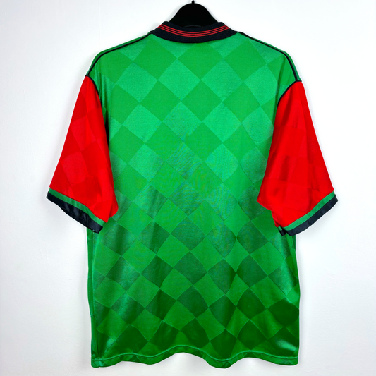 Rear view of Glentoran vintage football shirt produced by Umbro. Green body featuring red sleeves and grandad collar.