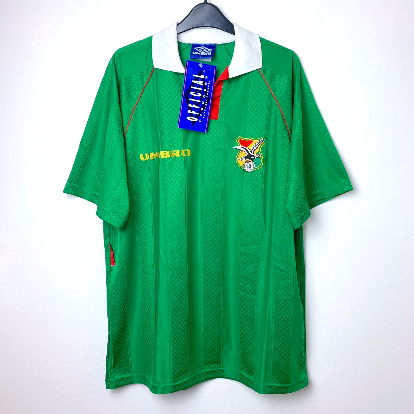 Green vintage Bolivia football shirt with Umbro logo and blue Umbro tag on a white background