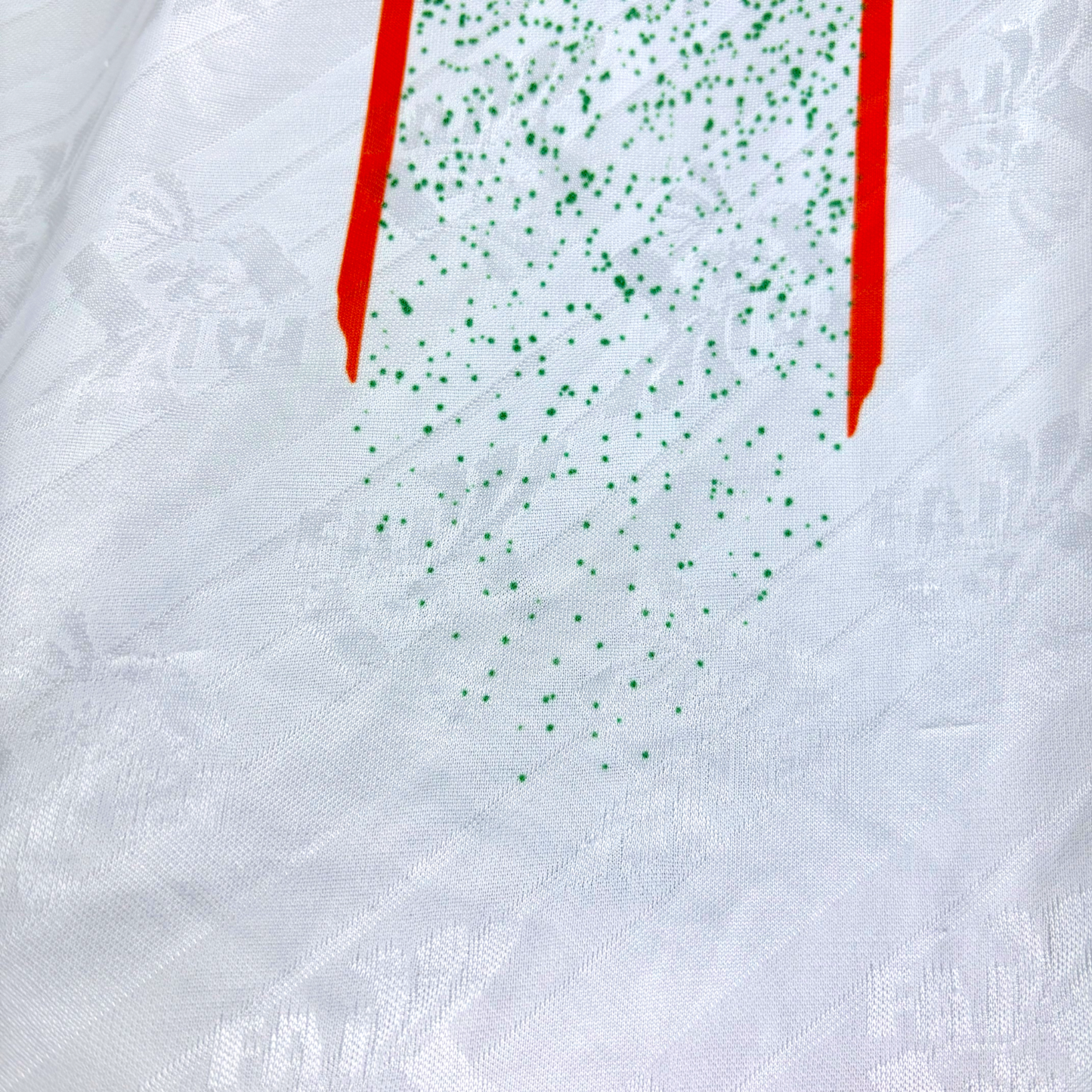 White vintage football shirt with green speckled graphic, red stripe details, and subtle embossed pattern. - Eire Ireland 1994-1995 USA World Cup Away Football Shirt Adidas