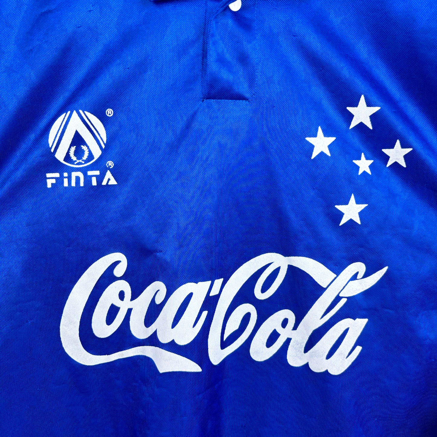 Close up view of vintage Cruzeiro 1993-1995 home football shirt with white Coca-Cola logo and Finta branding