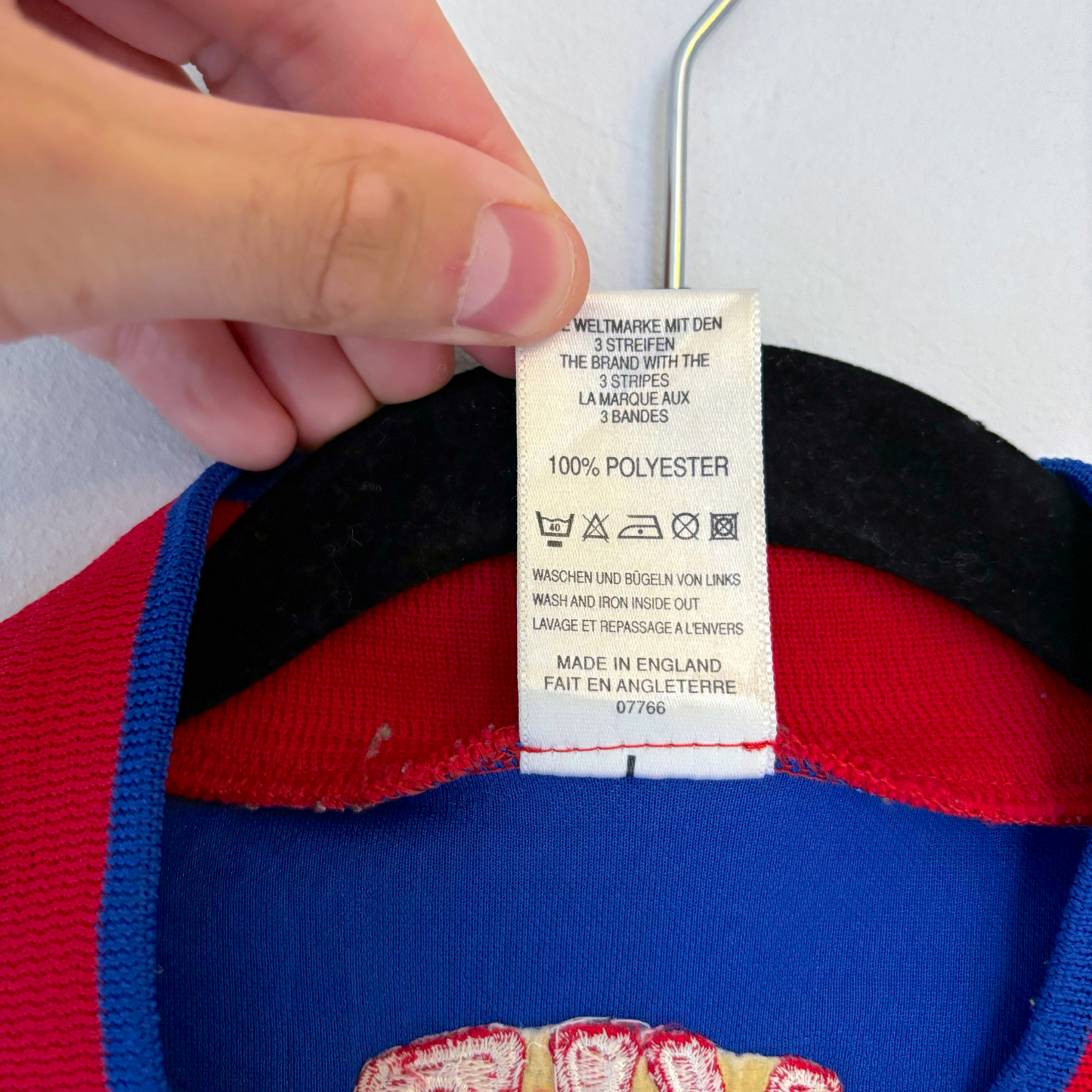 Valerenga VIF 1998-1999 vintage football shirt care tag showing Adidas 100% polyester label and manufacturing details. - Valerenga VIF 1998-1999 Home Football Shirt Jersey Adidas