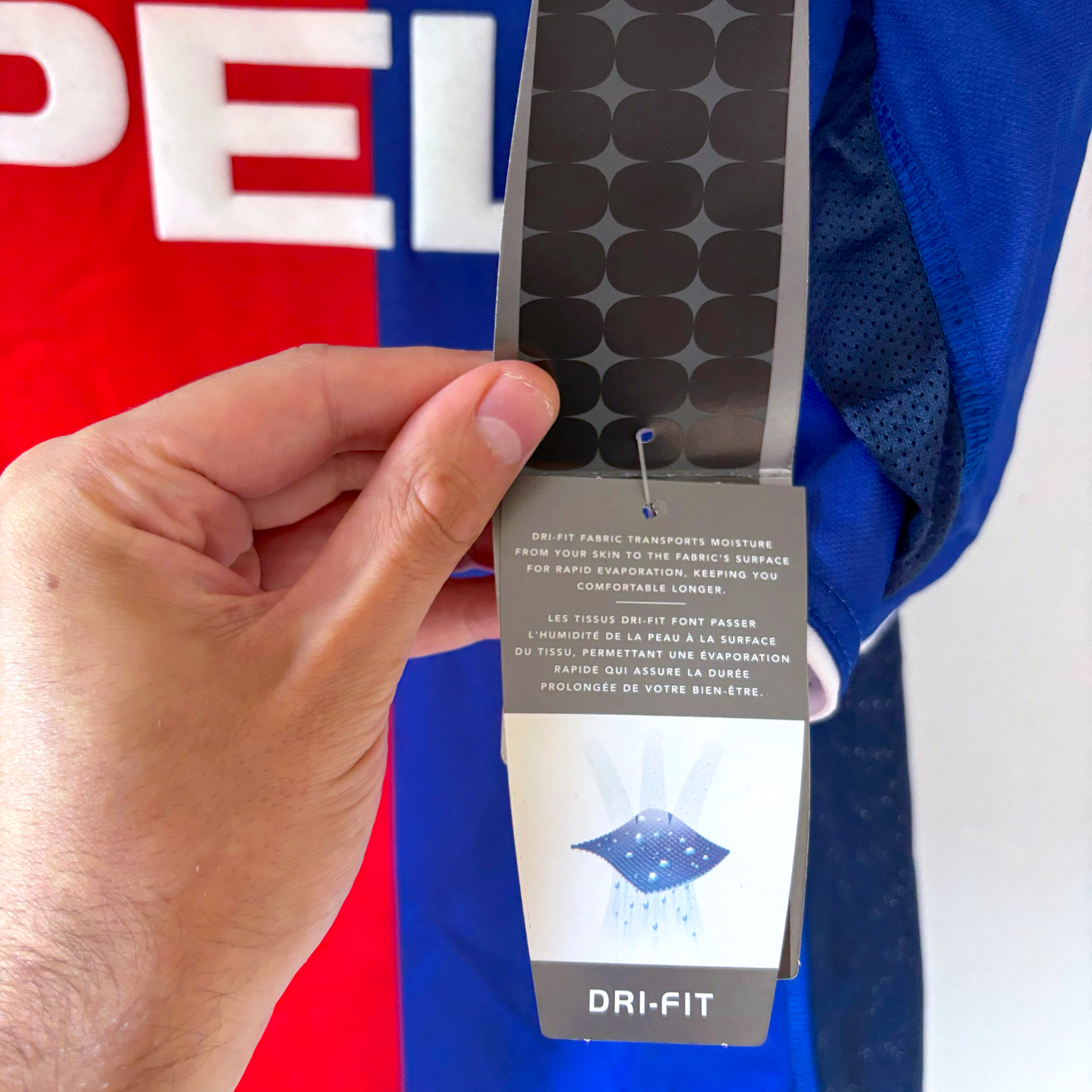 Hand holding black tag attached to blue vintage football shirt with Nike Dri-FIT label and Paris Saint Germain PSG 1999-2000 . - BWNT Paris Saint Germain PSG 1999-2000 Home Football Shirt Maillot Nike