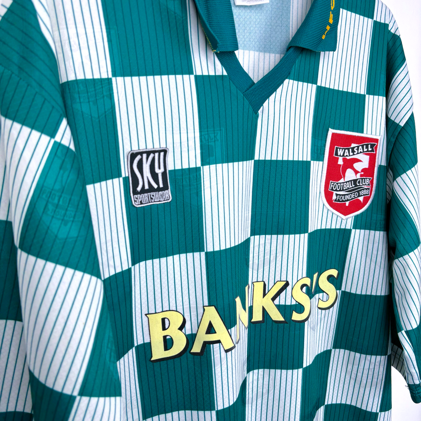 Side view of Walsall old football shirt made by Sky Leisure. Check green and off-white pattern with Banks's yellow sponsor.