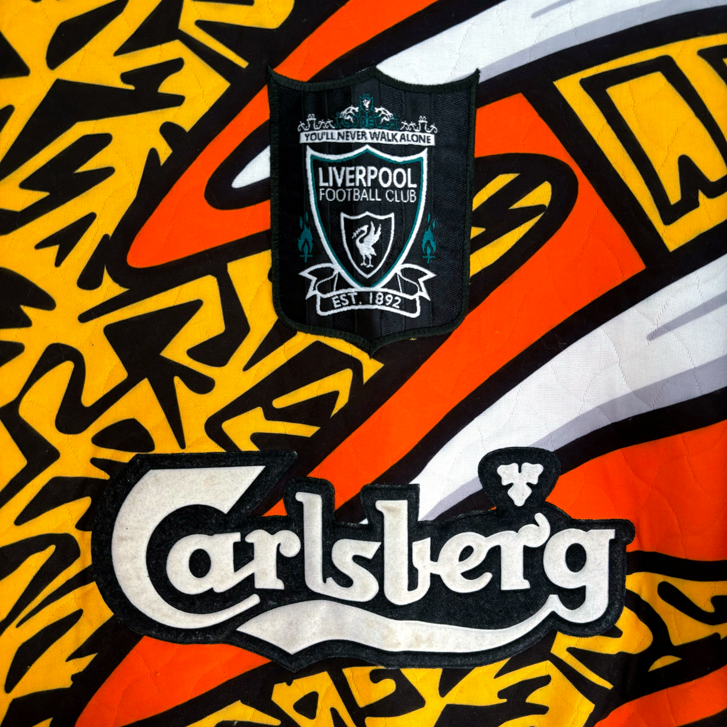 Liverpool FC 1995-1996 vintage football shirt Adidas with vibrant orange and black graphic pattern and Carlsberg sponsor logo. - Liverpool FC 1995-1996 Goal Keeper Football Shirt Adidas