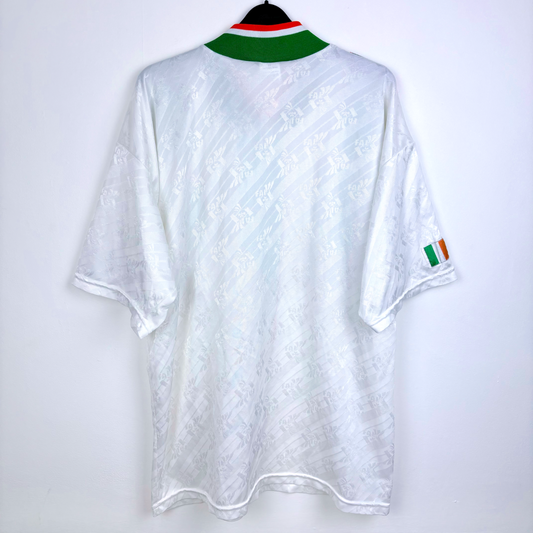 White vintage football shirt with subtle embossed pattern, green and red collar, Irish flag on sleeve, retro soccer jersey. - Eire Ireland 1994-1995 USA World Cup Away Football Shirt Adidas
