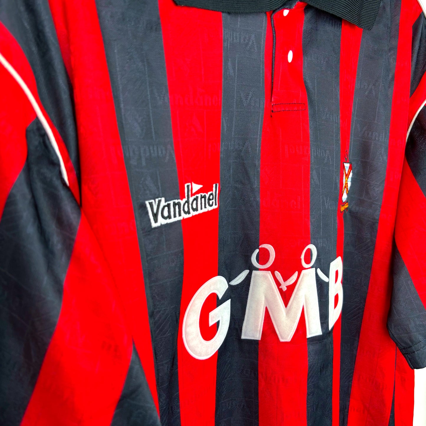 Side view of Fulham FC 1993-1994 away football shirt by Vandanel, red and black design with GMB sponsor, retro soccer jersey