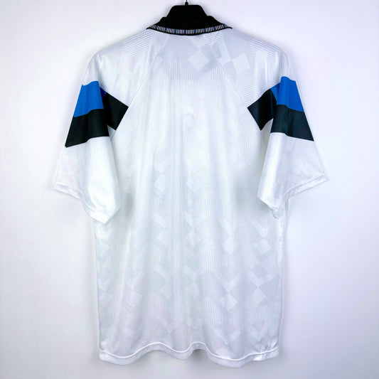 Rear view of Aston Villa 1990-1993 away classic football shirt made by Umbro. Sublimated jacquard pattern ion white body. Black and blue trim with black Mita Copiers sponsor.