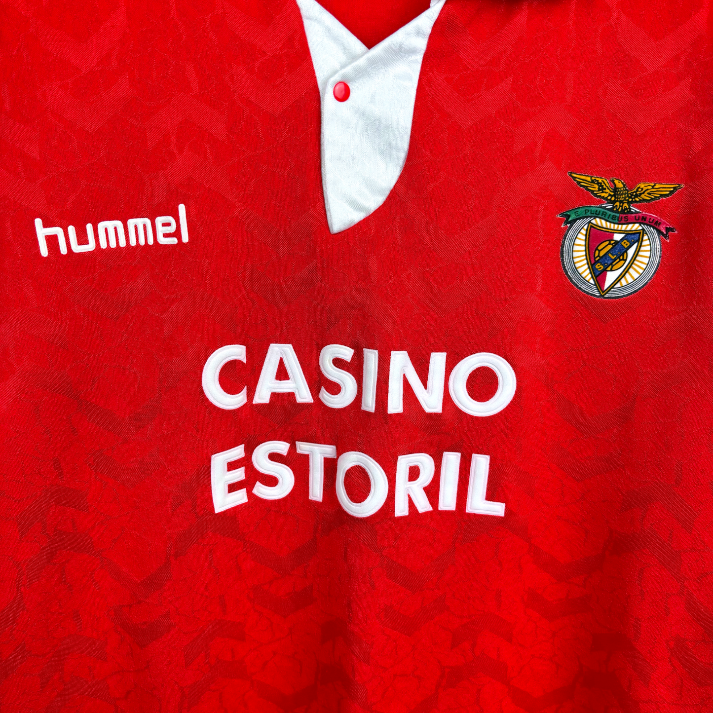 Retro Benfica home football shirt 'hummel' and 'Casino Estoril' text, featuring Benfica club crest. Red body with white trim.