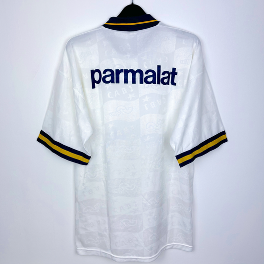 Rear view of Boca Juniors 1995-1996 away retro soccer jersey made by OLAN. White body featuring navy and gold accents. Parmalat sponsor in navy.