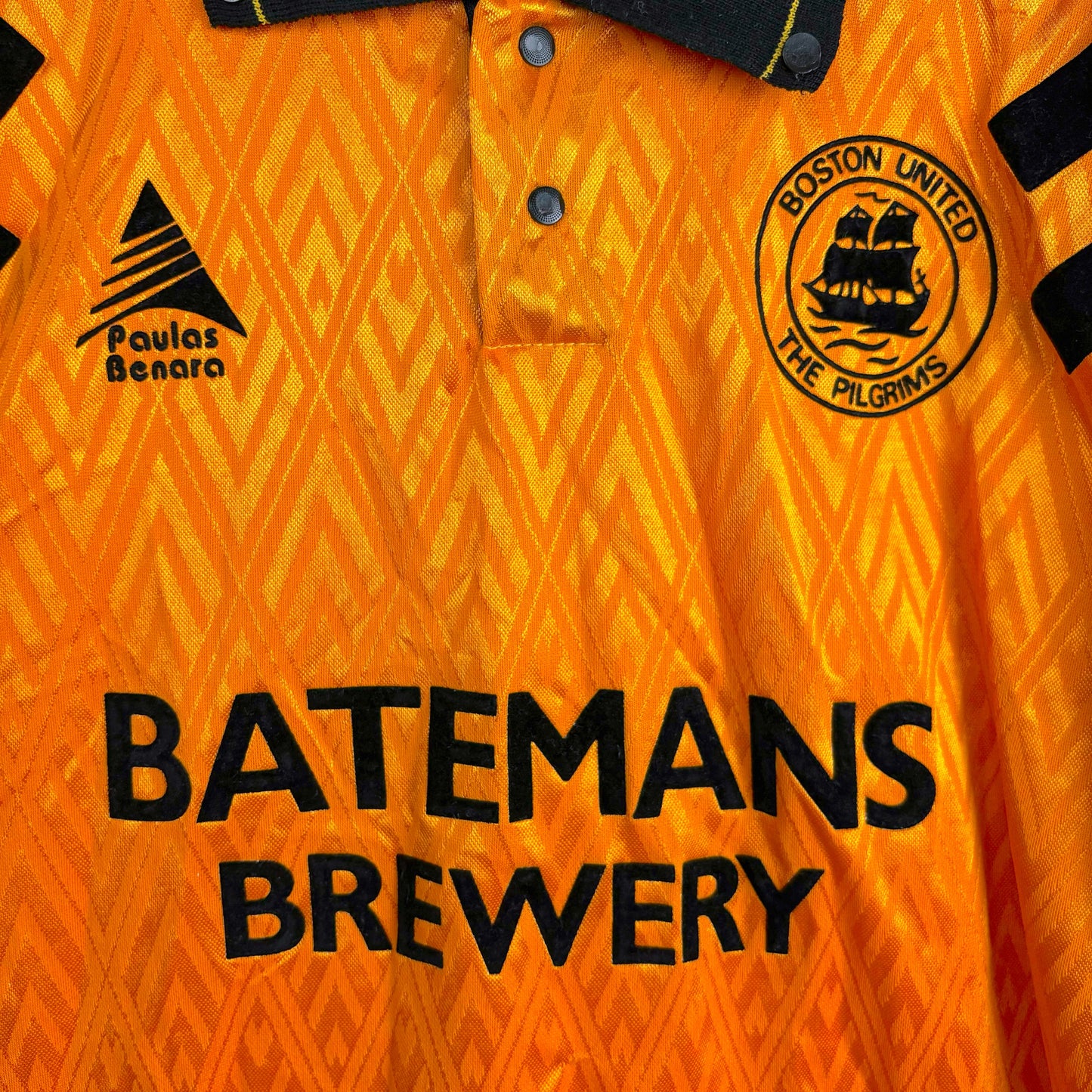 Boston United 1991-1993 Paulas Benara home football shirt, close-up of classic Batemans Brewery sponsor logo on orange and black design with Boston United badge