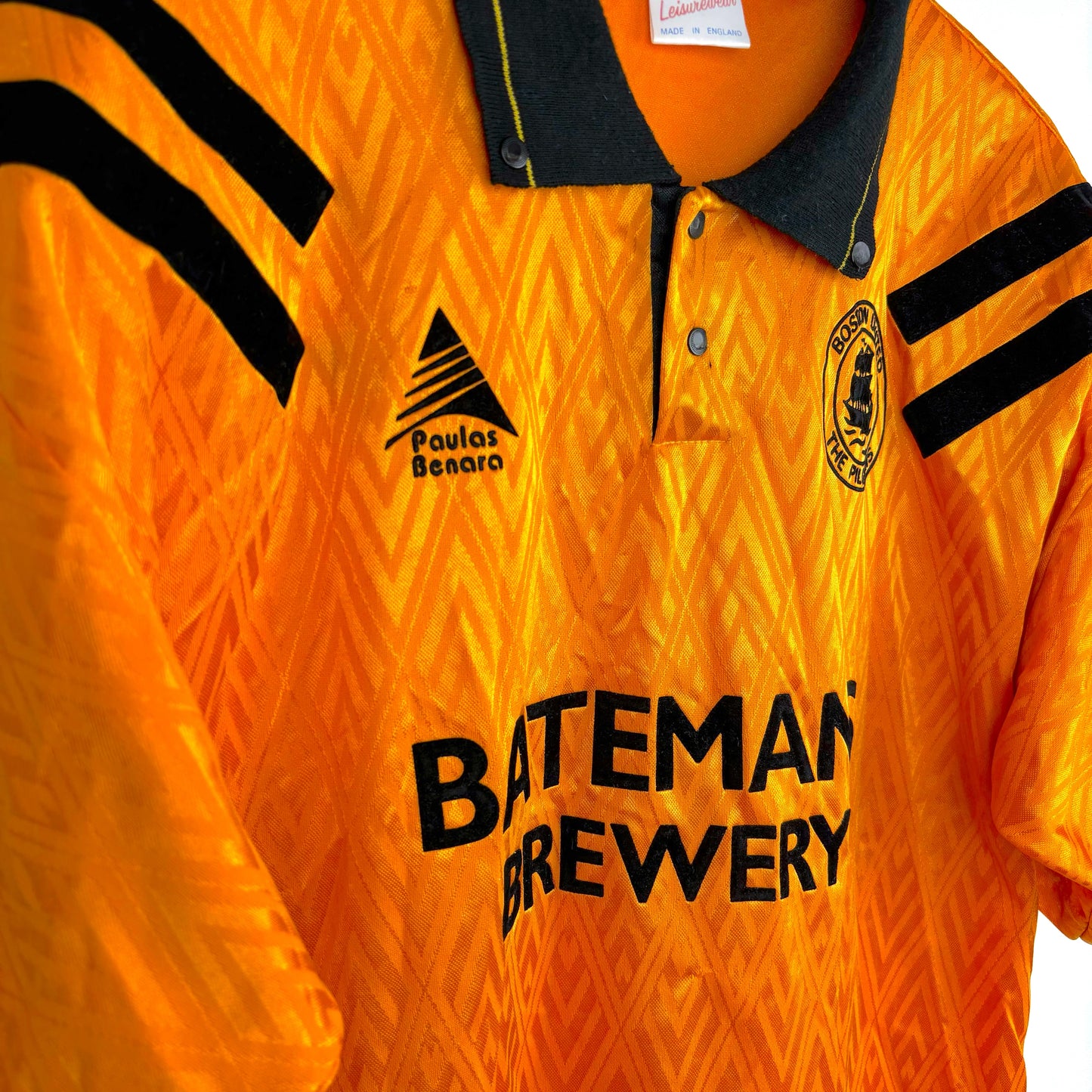 Vintage Boston United 1991-1993 Paulas Benara home football shirt, side view in orange with black trim