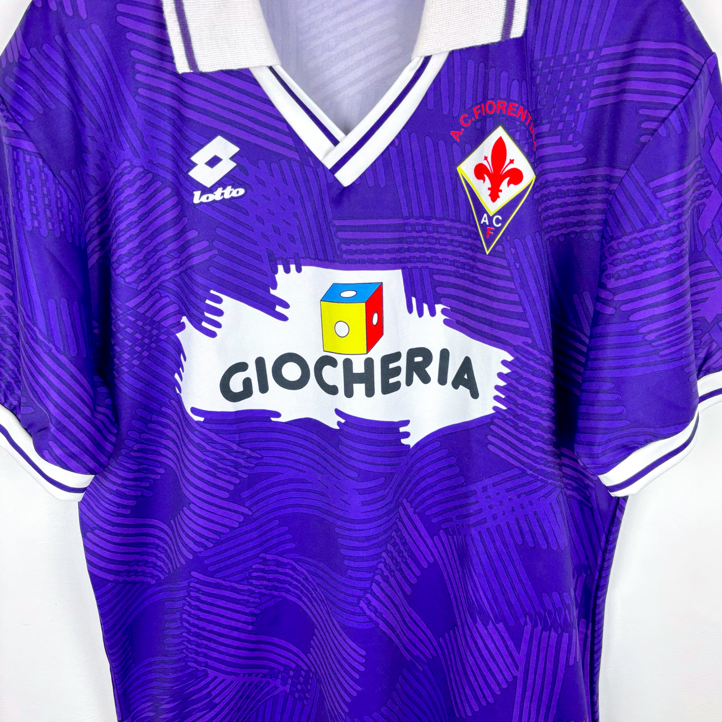 Fiorentina 1991-1992 classic home football shirt produced by Lotto. Purple body spanned by Lotto logo pattern and white collar.
