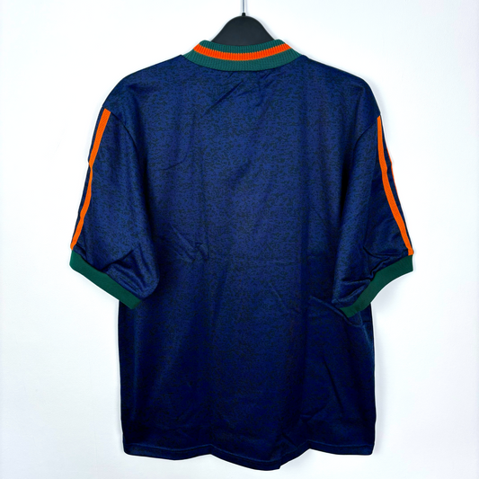 Rear view of Newcastle United vintage football shirt produced by Adidas. Navy body featuring duel green and orange stripes and crew neck collar.