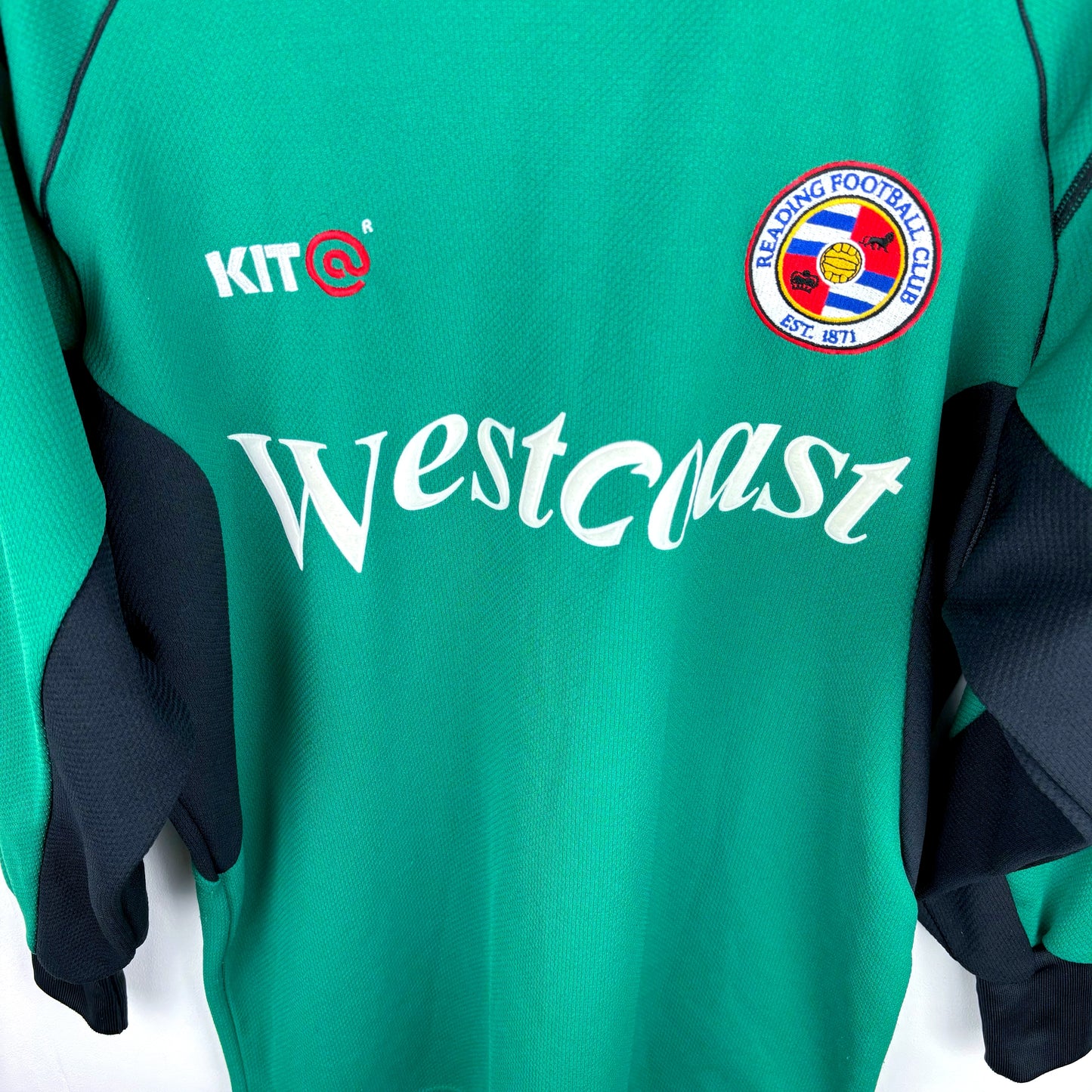 Angled close up view of vintage Reading FC 2001-2003 Goalkeeper Football Shirt. Green body complimented by classic black trim and Westcoast sponsor