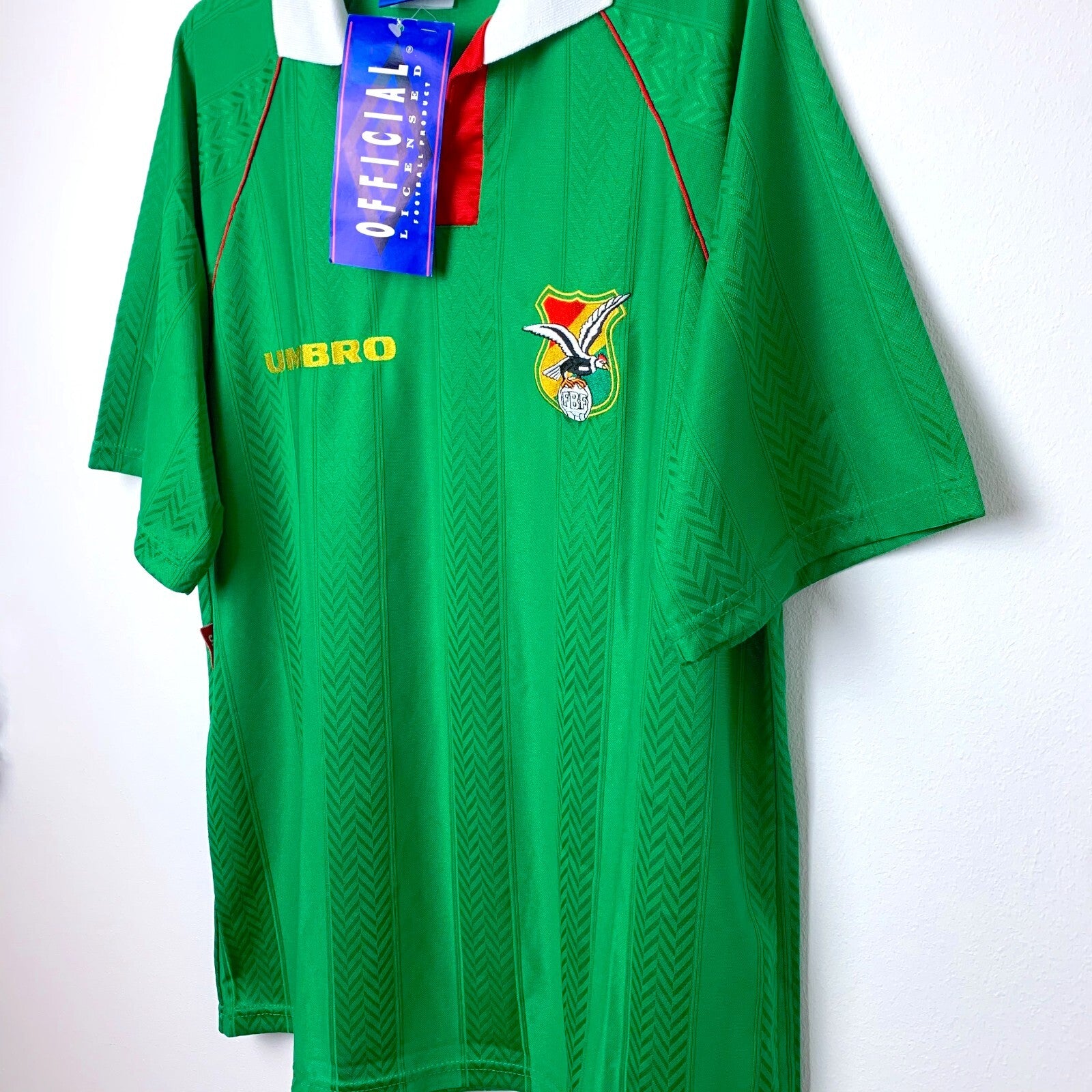 Side angled view of vintage Bolivia Umbro shirt as worn during 1994 World Cup