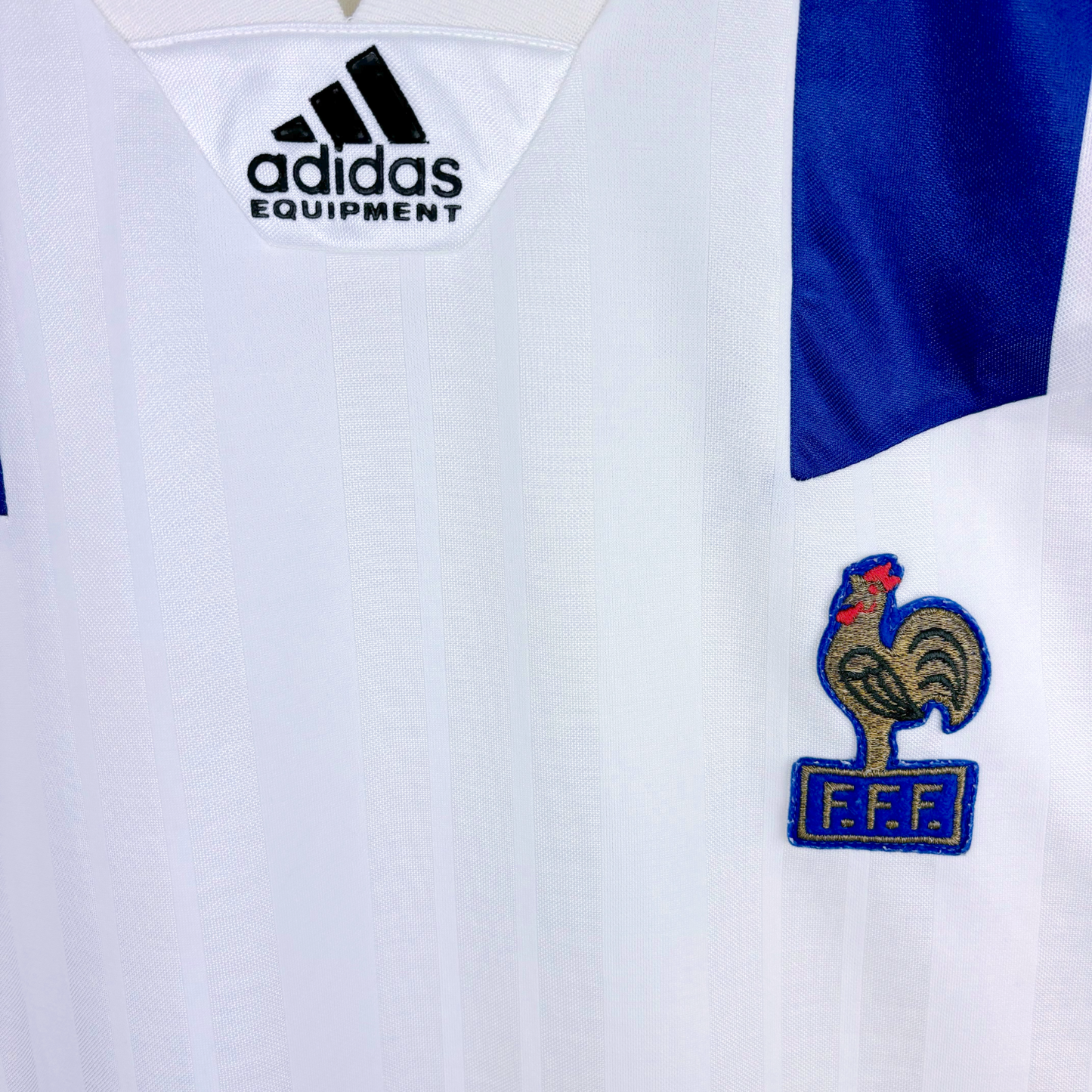 White vintage football shirt with blue shoulder panels, Adidas logo, and French Football Federation crest. - Équipe de France FFF 1992/1993/1994 Away Football Maillot Shirt Adidas
