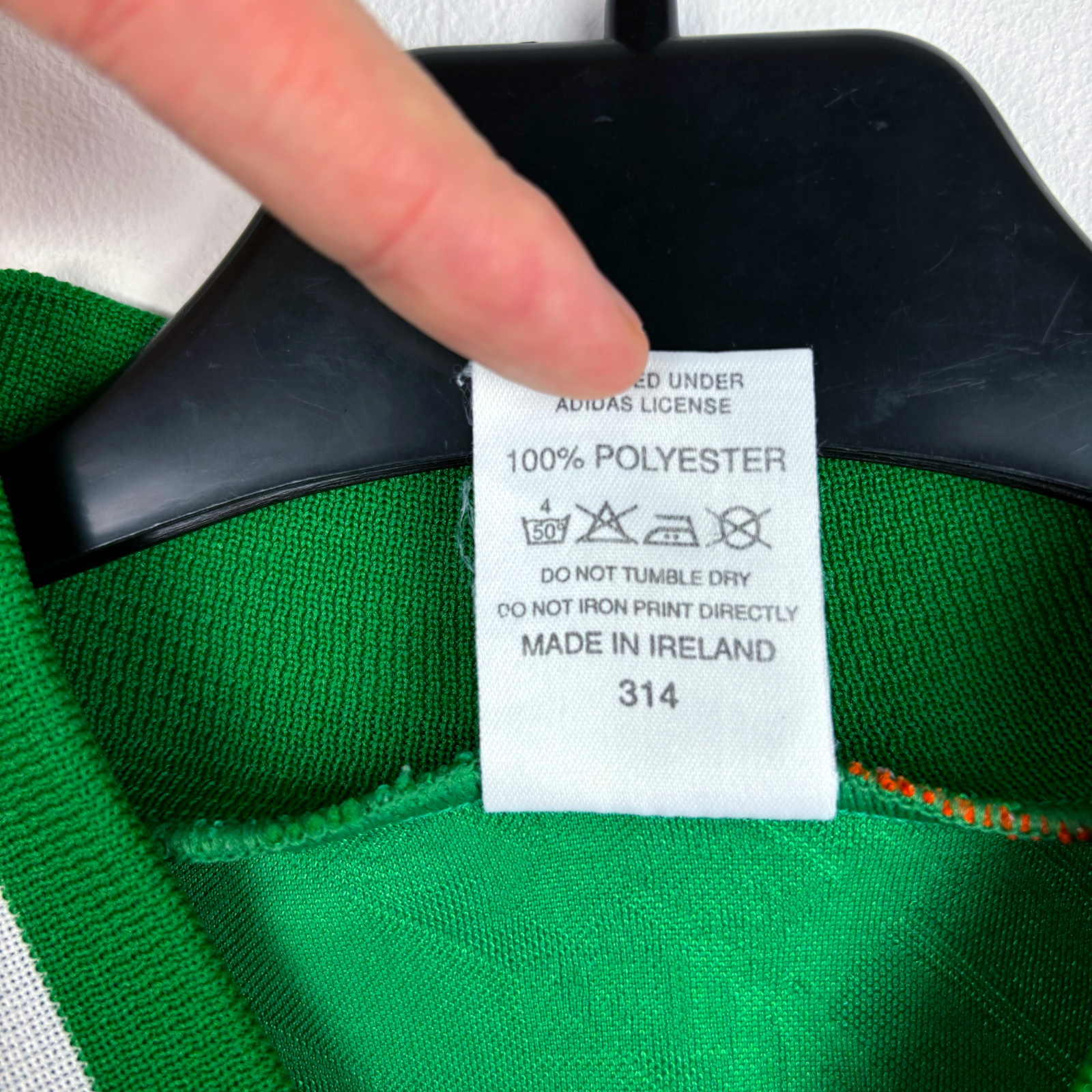Tag inside vintage football shirt showing 100% polyester and made in Ireland label on green fabric. - Eire Ireland 1994-1995 USA World Cup Home Football Shirt Adidas