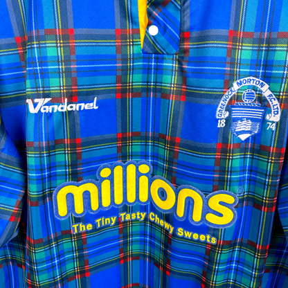 Close up view of Greenock Morton retro soccer jersey produced by Vandanel. Tartan design with yellow 'Millions' candy logo and embroidered Greenock crest.