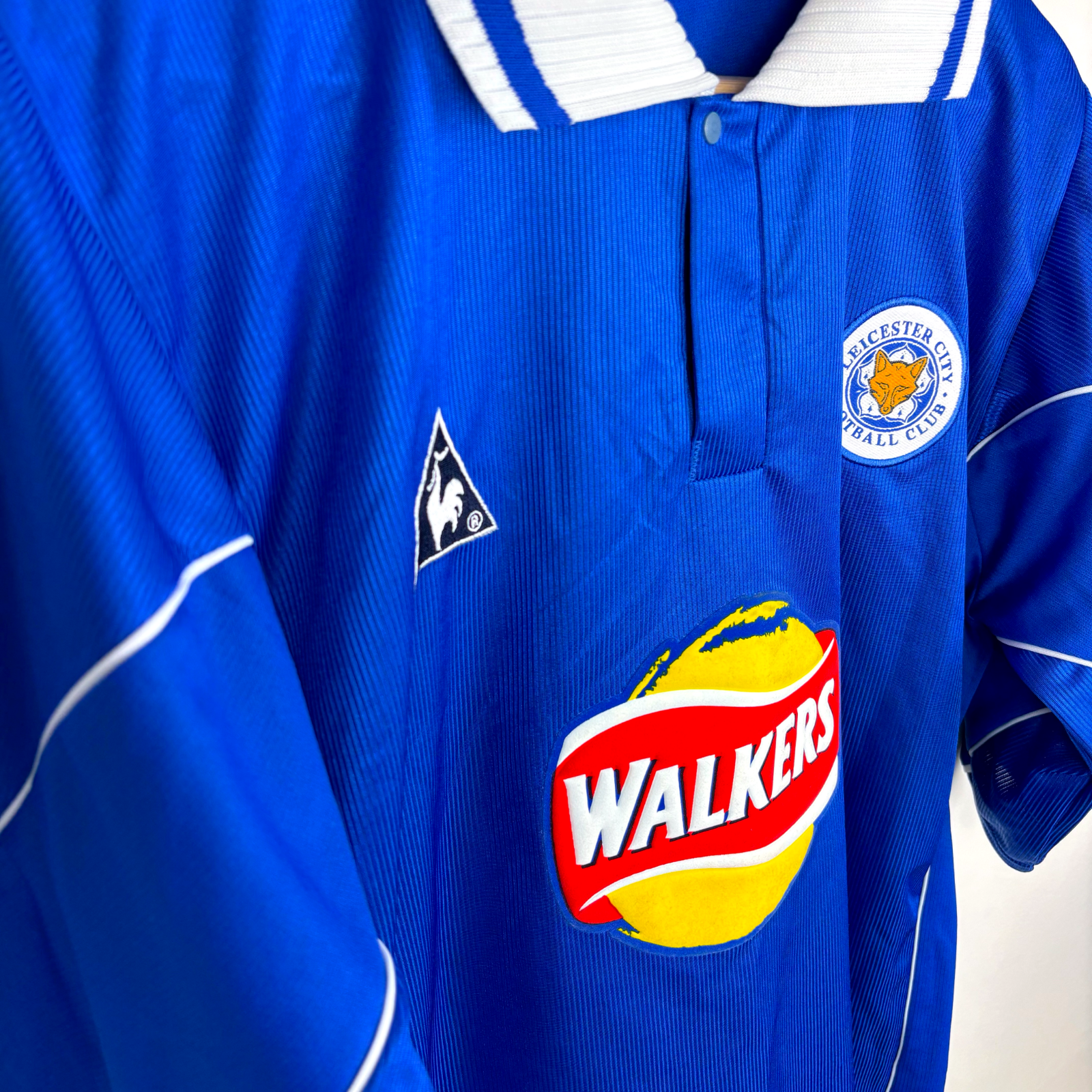 Vintage Leicester City 2000-2001 home football shirt in blue with white collar, Le Coq Sportif logo, and Walkers sponsor. - MINT Leicester City 2000-2001 Home Football Shirt Le Coq Sportif