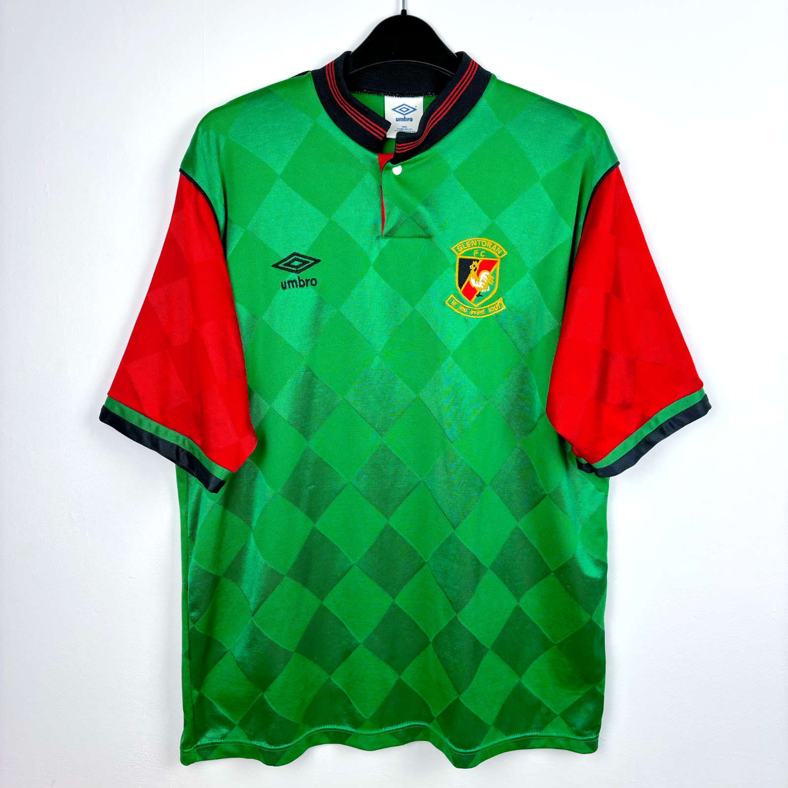 Glentoran classic football shirt produced by Umbro. Green body featuring red sleeves and grandad collar.