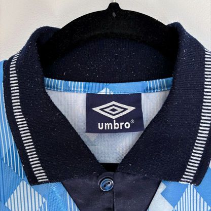 Vintage football shirt collar and Umbro label on blue retro football shirt fabric with white and navy accents. - England 1990/1991/1992 Third 3rd Blue Umbro Football Shirt Reissue