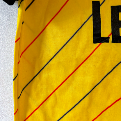 Yellow Millwall 1987-1989 vintage football shirt with red and blue diagonal stripes, close-up of fabric and sleeve edge of. - Millwall 1987/1988/1989 Away Football Shirt Spall