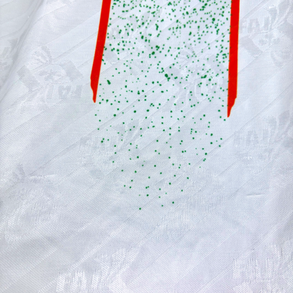 White vintage football shirt with green speckled graphic, red stripe details, and subtle embossed pattern. - Eire Ireland 1994-1995 USA World Cup Away Football Shirt Adidas