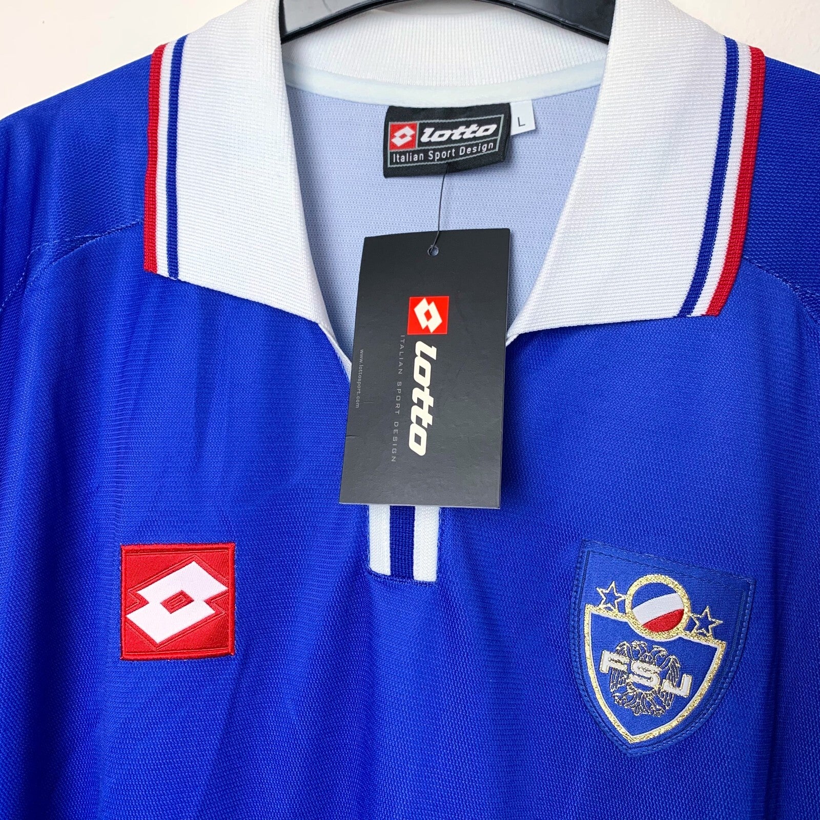 Close up view of 2002 Yugoslavia shirt by Lotto with embroidered Lotto logo and embroidered Yugoslavia national team badge