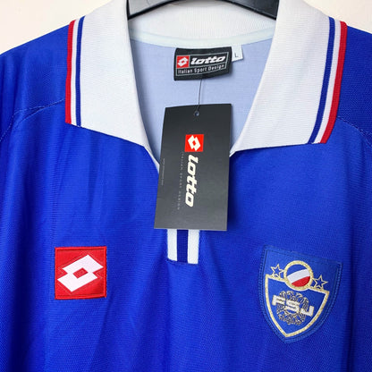 Close up view of 2002 Yugoslavia shirt by Lotto with embroidered Lotto logo and embroidered Yugoslavia national team badge