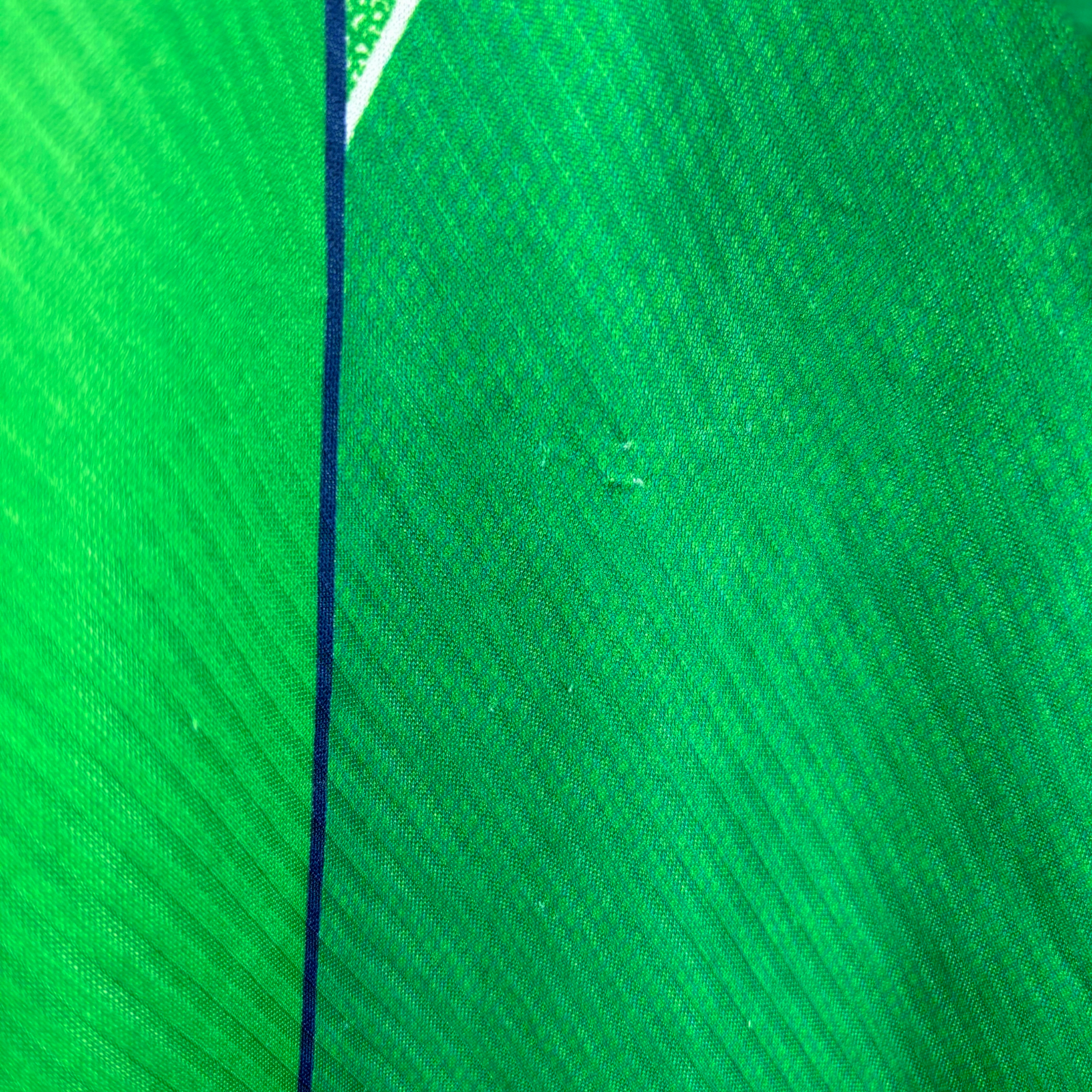 Green vintage football shirt with dark blue trim and textured diagonal pattern, classic retro soccer jersey style. - Eire Ireland 1994/1995/1996 Home Football Shirt Umbro