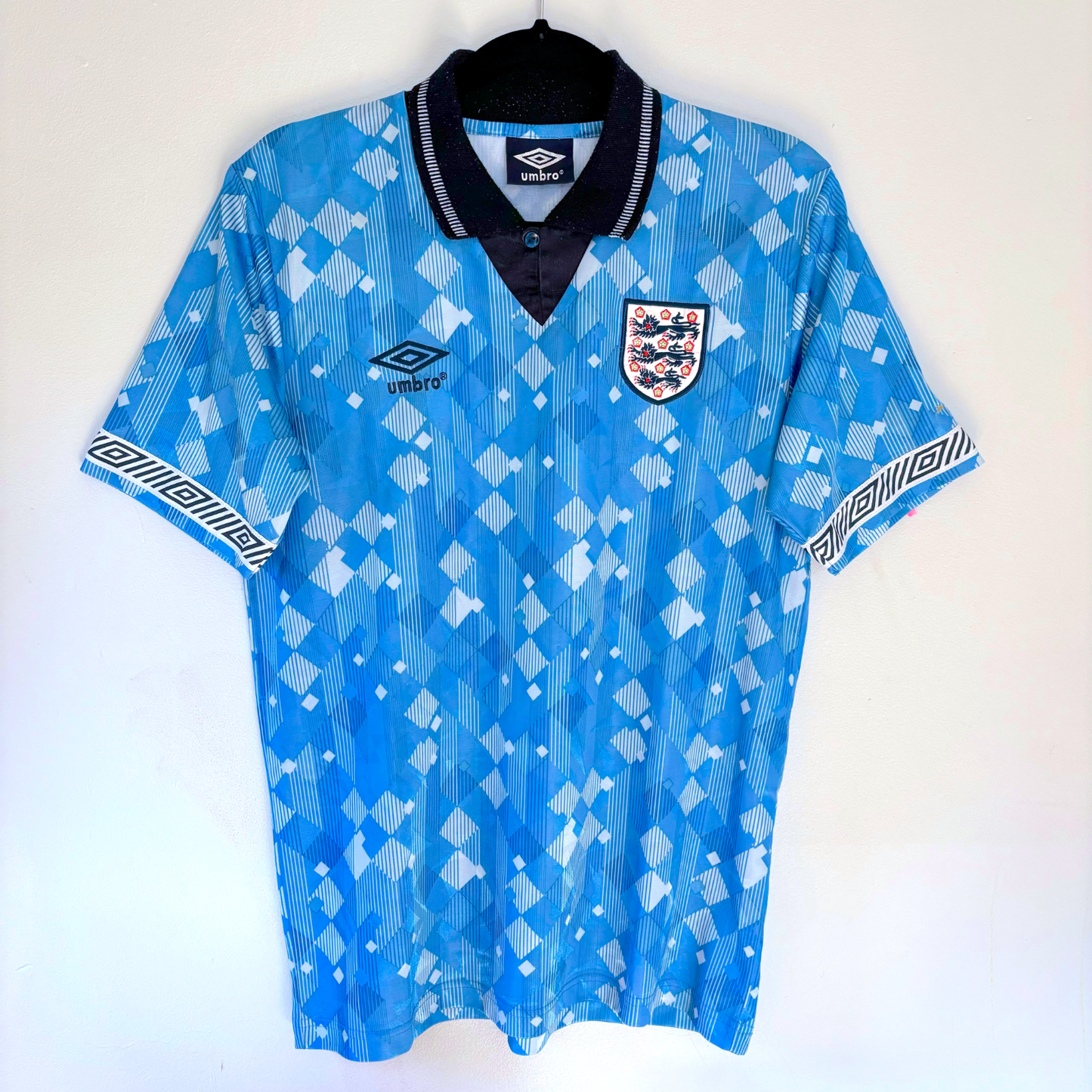 England 1990-1992 vintage football shirt in blue with diamond pattern, Umbro logo, and Three Lions crest, a classic retro. - England 1990/1991/1992 Third 3rd Blue Umbro Football Shirt Reissue