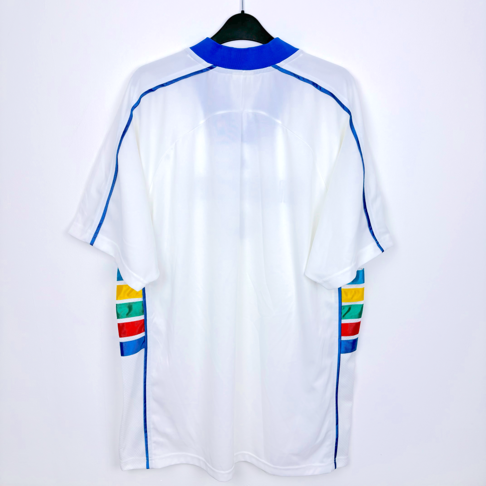 Rear view of white Kansas City 1997-1998 vintage soccer jersey produced by Adidas. White body featuring rainbow coloured side panels.