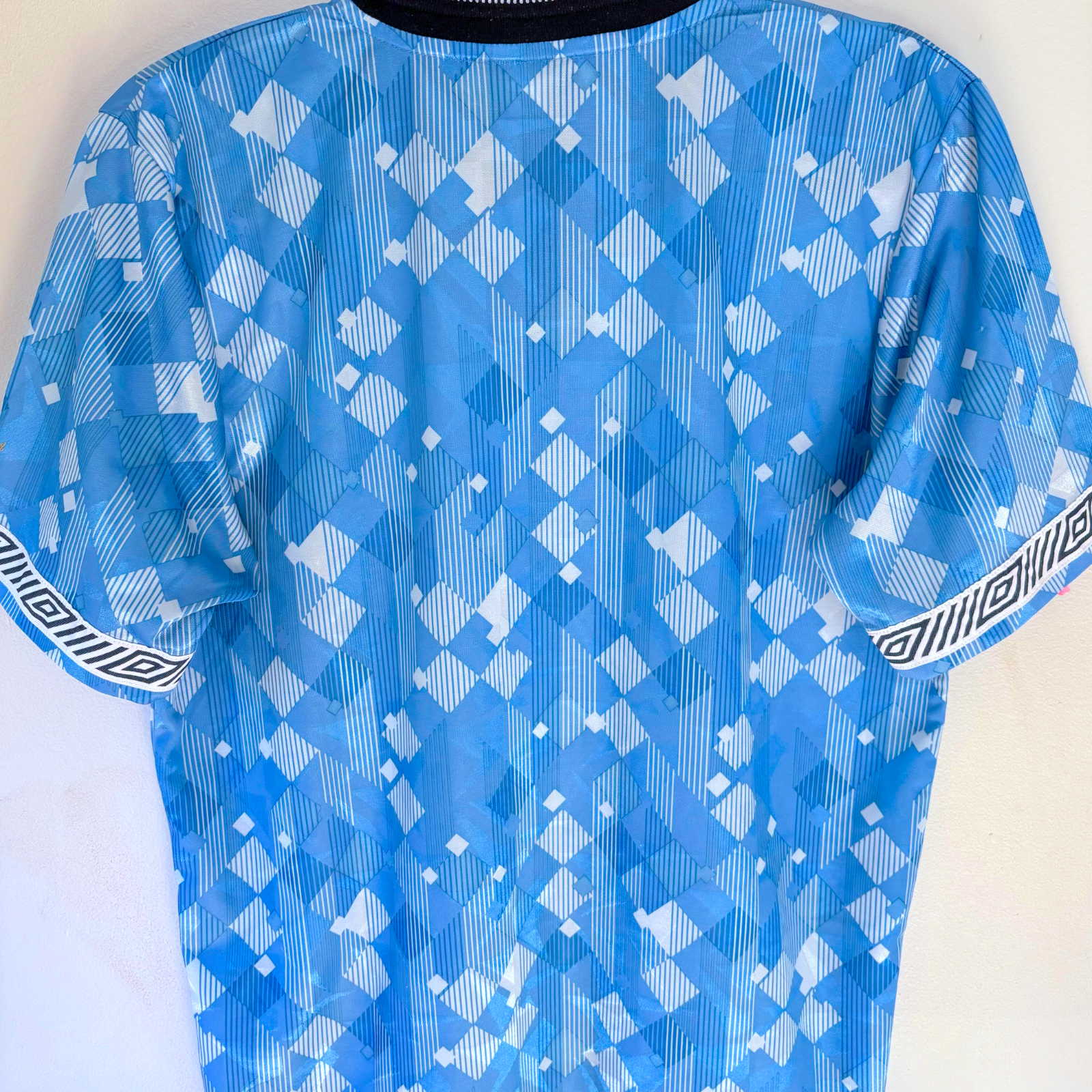 Vintage retro football shirt in blue with abstract geometric pattern and Umbro logo trim on sleeves. - England 1990/1991/1992 Third 3rd Blue Umbro Football Shirt Reissue