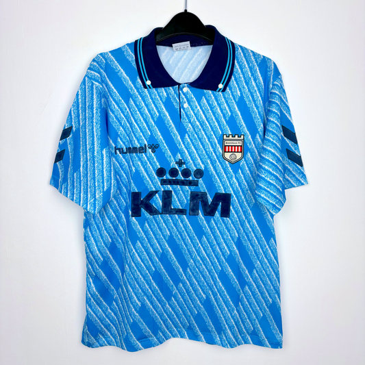 1992 Brentford vintage away football shirt made by Hummel. Geometrical sky-blue pattern and navy collar. KLM airlines sponsor.