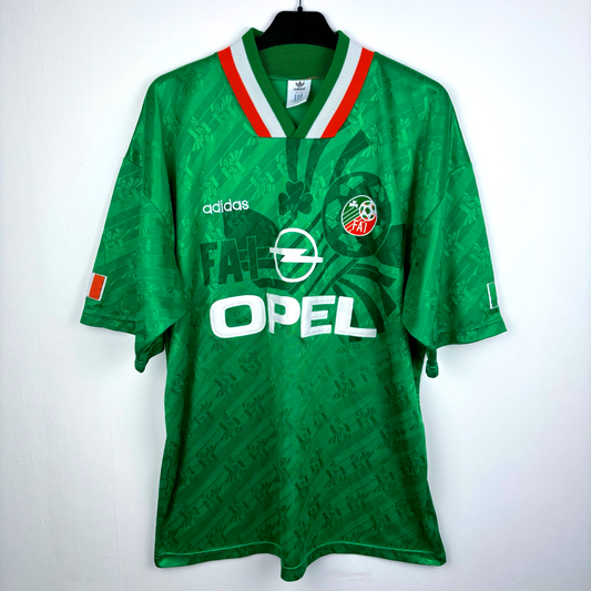 Green vintage football shirt with Ireland 1994-1995 crest, Adidas logo, and Opel sponsor, retro soccer jersey style. - Eire Ireland 1994-1995 USA World Cup Home Football Shirt Adidas