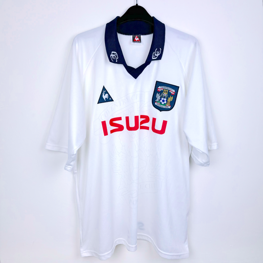 Frront view of white Coventry City vintage football shirt produced by le coq sportif. Embroidered Coventry badge with red Izuzu sponsor.