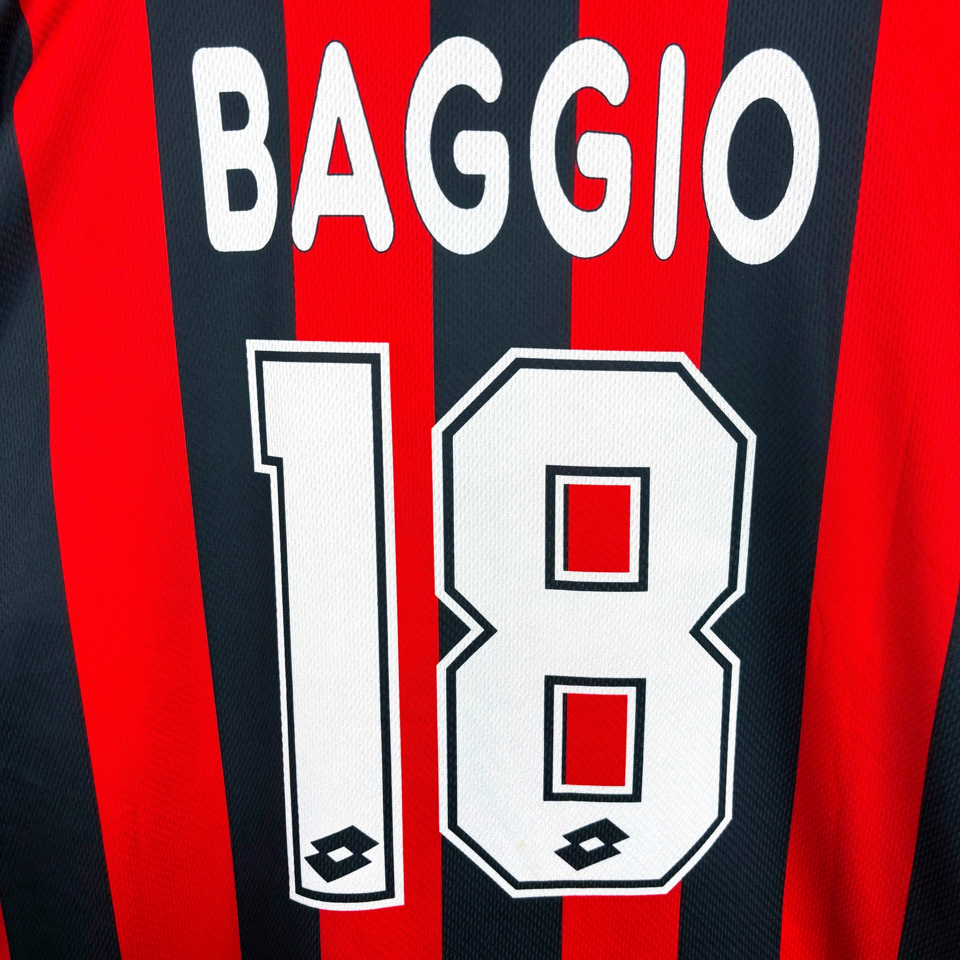Close-up of sublimated Baggio 18 name-set on AC Milan 1996-1997 Lotto home vintage football jersey. Red and black stripes.