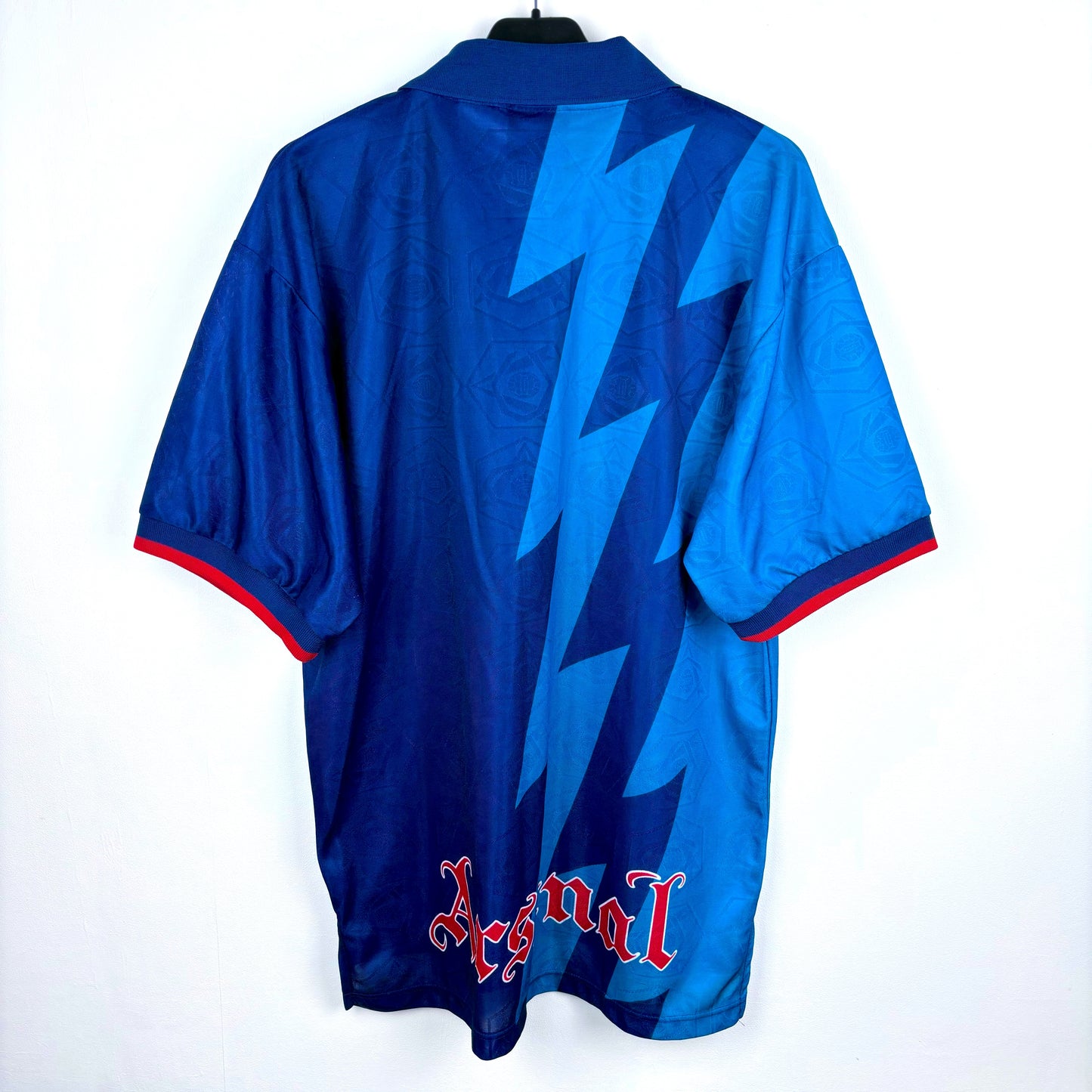 Rear view of Arsenal 1995-1996 Nike away classic football shirt. Two-tone navy and blue body with lightning bolt pattern. JVC sponsor.