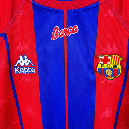 Badges close up on FC Barcelona 1997-1998 home vintage soccer jersey made by Kappa. Red and blue stripes with embroidered badge.