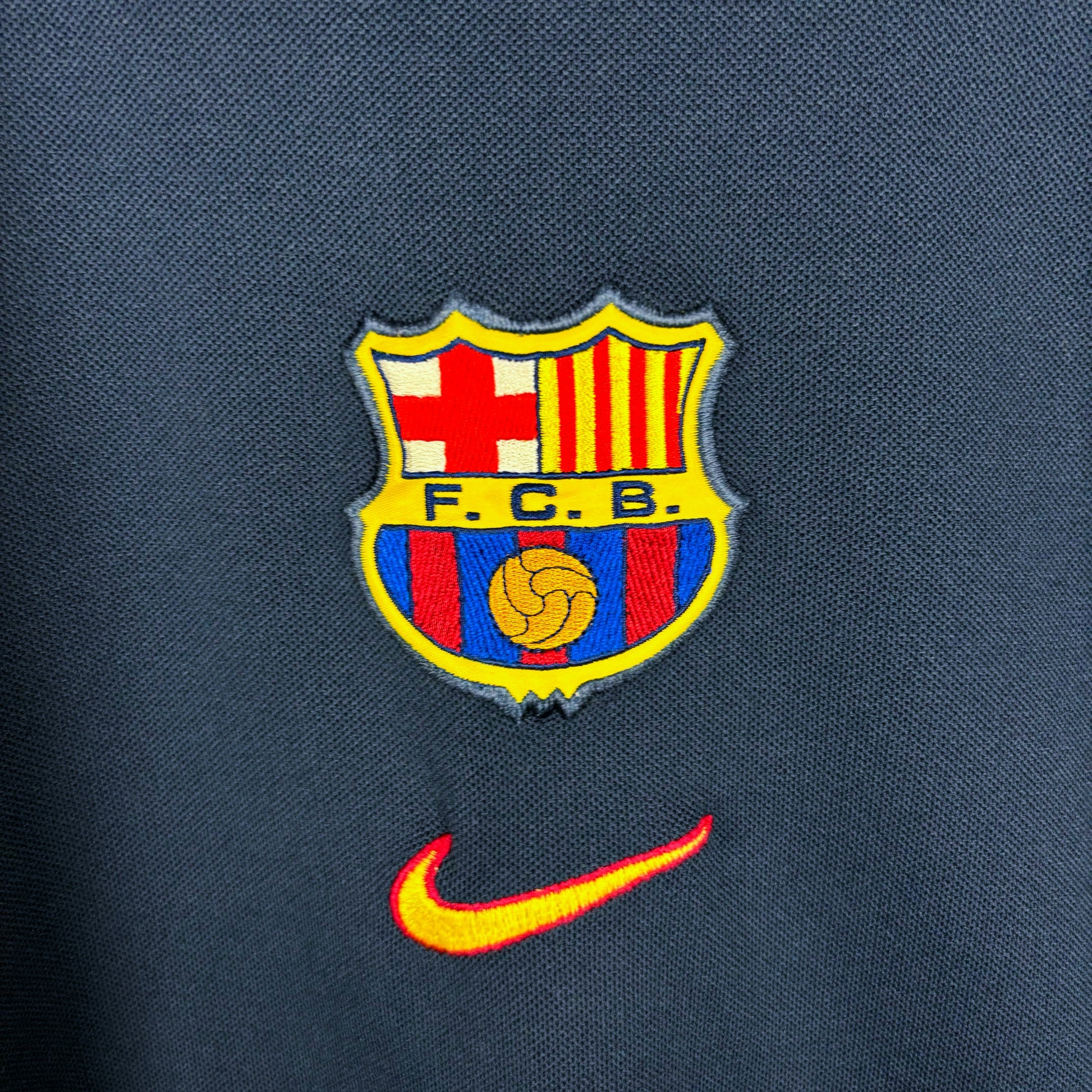 Close up of embroidered Nike and club badges on Barcelona 2000-2001 vintage training sweatshirt. 