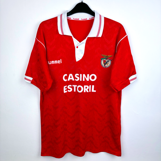 Classic Benfica home football shirt 'hummel' and 'Casino Estoril' text, featuring Benfica club crest. Red body with white trim.