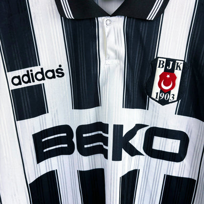Close up of club badge and BEKO sponsor. Besiktas 1996-1997 away adidas retro soccer jersey with black and white stripes.