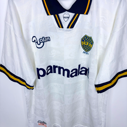 Downward view of Boca Juniors 1995-1996 away vintage soccer jersey produced by OLAN. White body featuring navy and gold accents. 