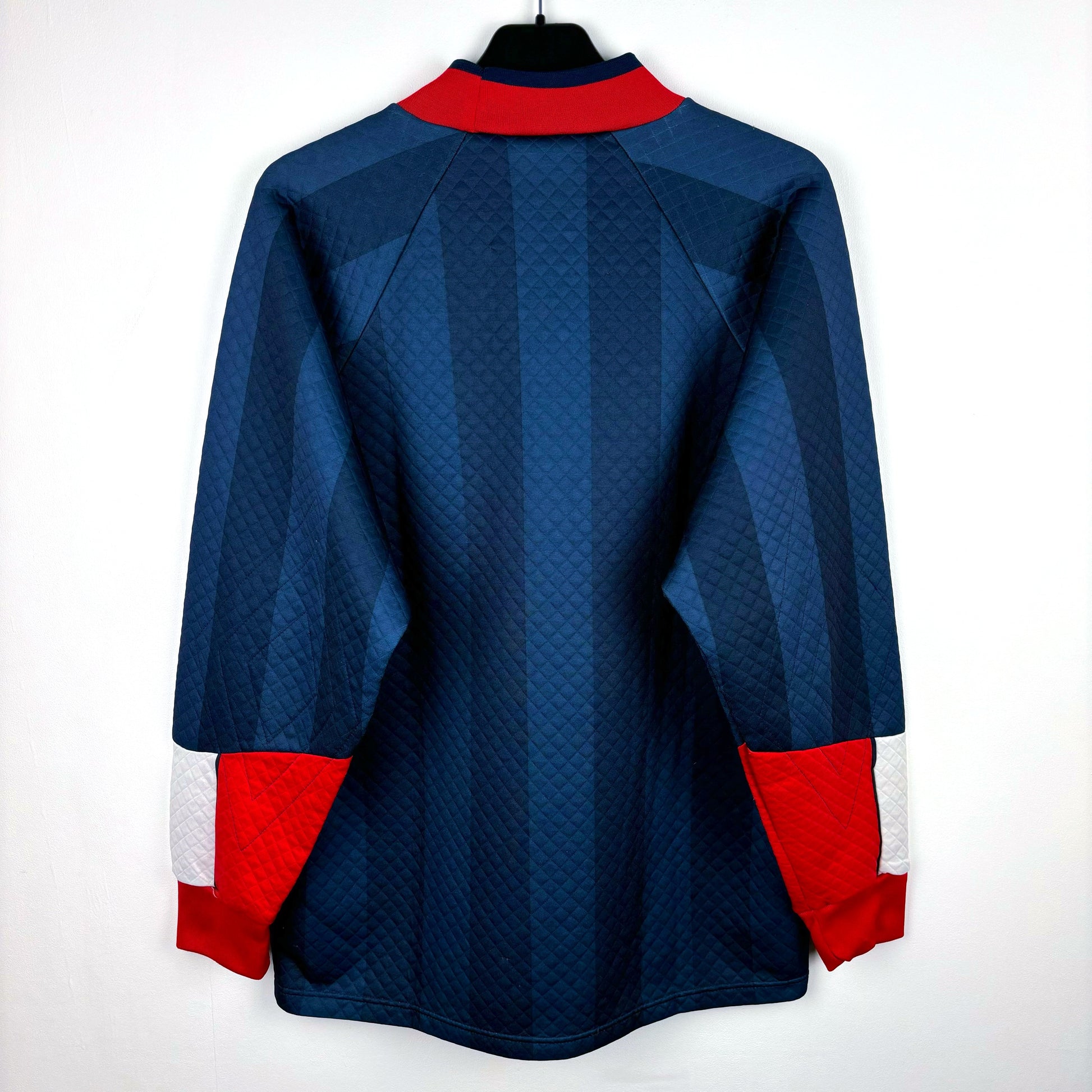 Reverse view of England 1997-1998 goalkeeper vintage football shirt made by Umbro. Dual navy body with red collar and tipped sleeves. Worn during 1998 World Cup.
