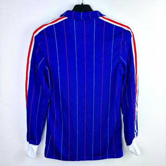 Rear view of a France 1980-1982 adidas classic football shirt. Blue body with alternating red and white pinstripes.