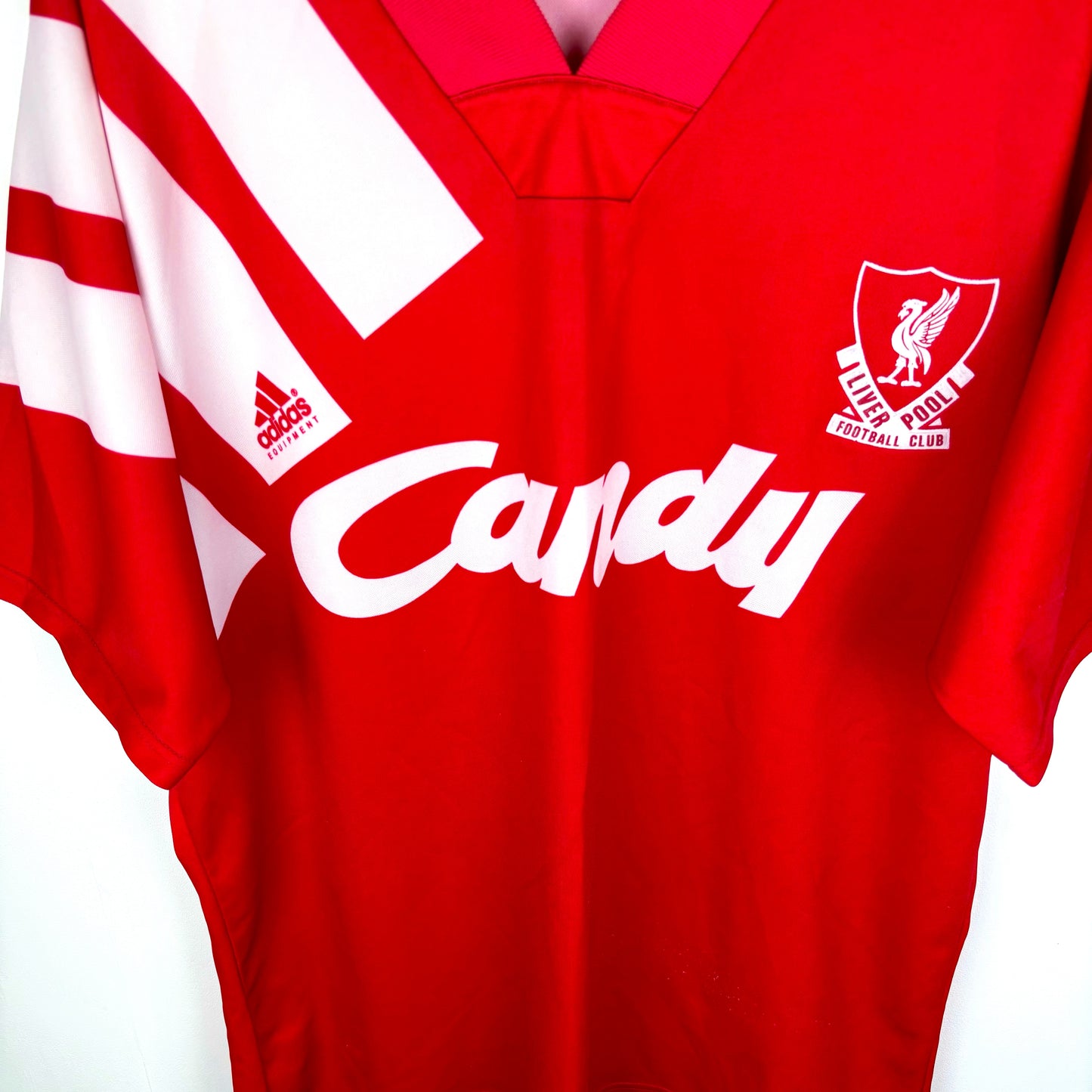 Angled view of Liverpool 1991-1992 adidas home retro football shirt. Red body with three white shoulder stripes. Candy sponsor.
