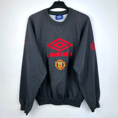 Front view of 1992-1994 Manchester United grey Umbro sweatshirt – vintage football shirt style with classic Umbro logo and Manchester United crest, ideal for fans of retro soccer jerseys and football classics shirts.